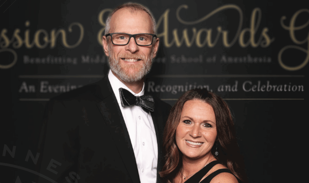Rusty Gentry and wife smiling at awards ceremony