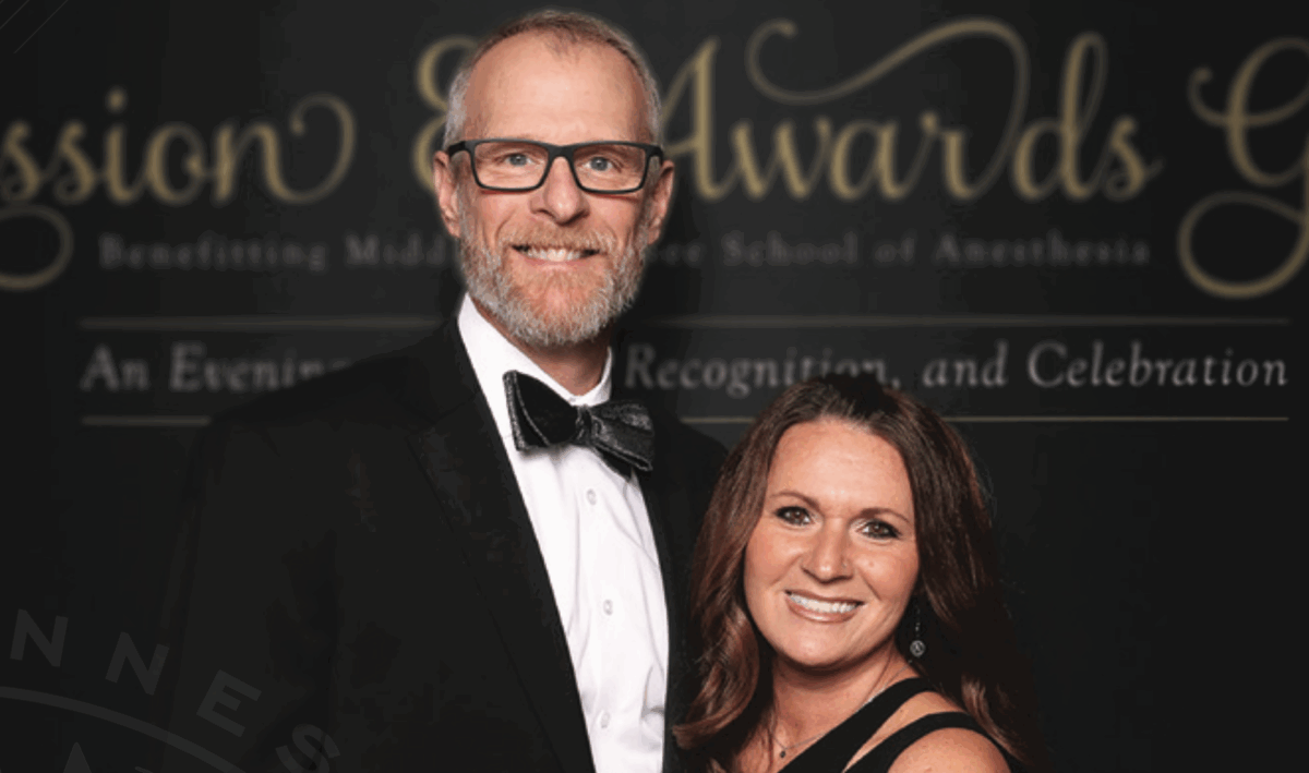 Rusty Gentry and wife smiling at awards ceremony